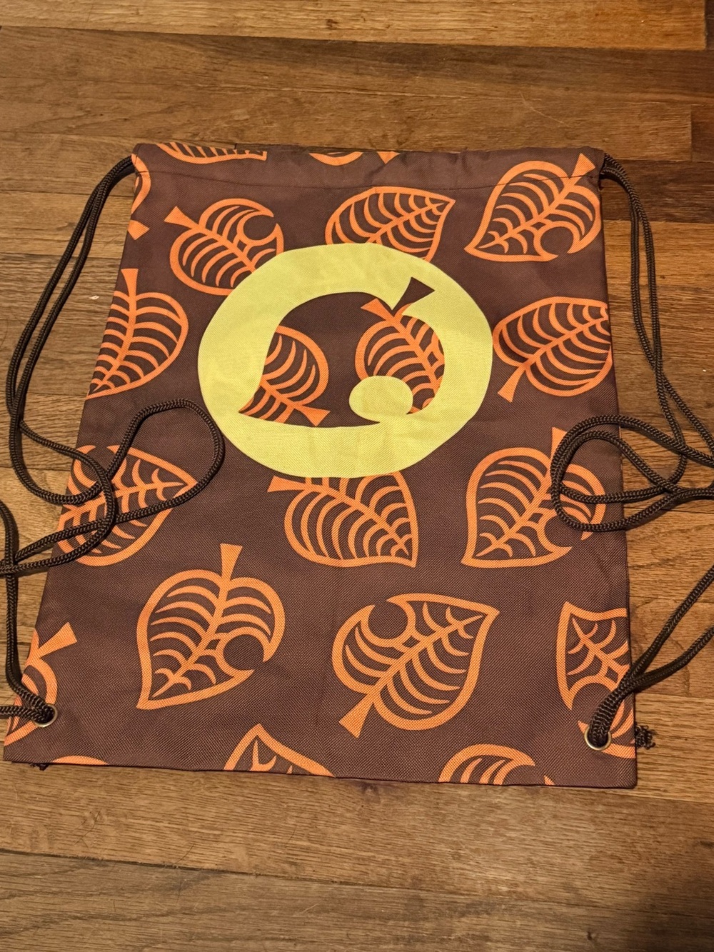 Animal Crossing Drawstring Backpack with Orange Leaf Print and Yellow Badge